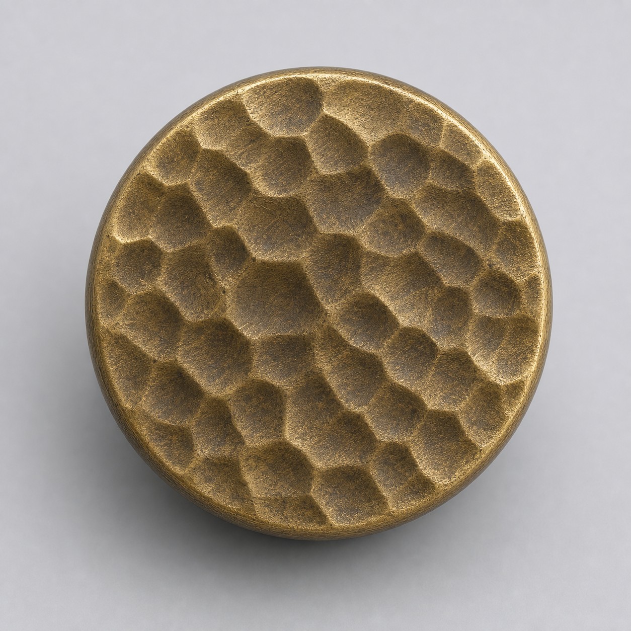 Close view of hammered antique brass knob top texture